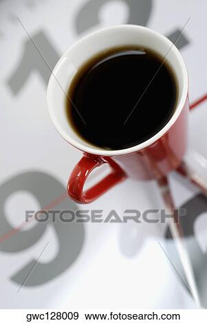 High angle view of a cup of black tea on a clock View Large Photo Image Stock Photo - High angle view of a cup of black tea on a clock. Fotosearch