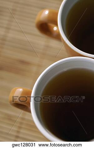 High angle view of two cups of black tea View Large Photo Image Stock Image - High angle view of two cups of black tea. Fotosearch