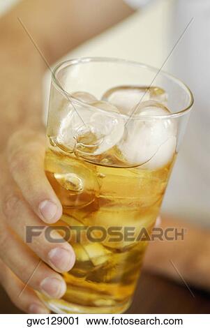 Close-up of a human hand holding a glass of whiskey View Large Photo Image Stock Image - Close-up of a human hand holding a glass of whiskey. Fotosearch