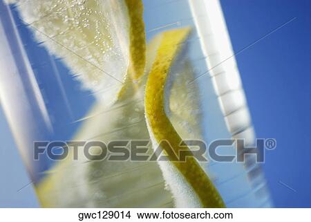 Close-up of a lemon slice in a glass View Large Photo Image Picture - Close-up of a lemon slice in a glass. Fotosearch