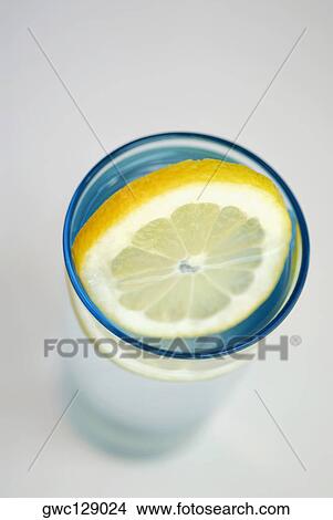 Close-up of a lemon slice in a glass View Large Photo Image Picture - Close-up of a lemon slice in a glass. Fotosearch
