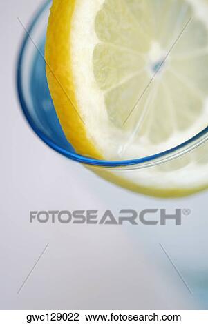 Close-up of a slice of lemon in a glass View Large Photo Image Stock Image - Close-up of a slice of lemon in a glass. Fotosearch