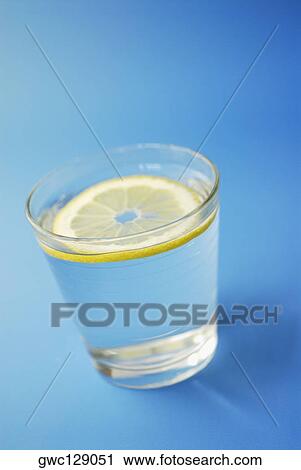 Stock Image - Close-up of a slice of lemon in a glass. Fotosearch