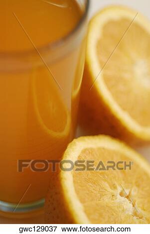Close-up of orange juice with two orange slices View Large Photo Image Stock Photo - Close-up of orange juice with two orange slices. Fotosearch