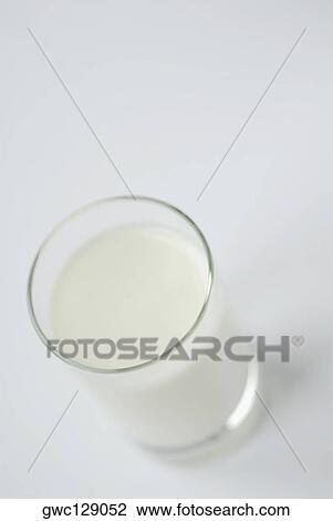 Stock Image - High angle view of a glass of milk. Fotosearch