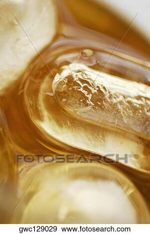 Ice cubes in a glass of ice tea View Large Photo Image Stock Photo - Ice cubes in a glass of ice tea. Fotosearch