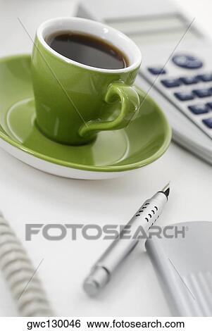 Close-up of a cup of black tea with a pen and a telephone receiver View Large Photo Image Stock Photograph - Close-up of a cup of black tea with a pen and a telephone receiver. Fotosearch