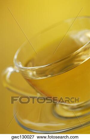Close-up of a cup of herbal tea on a saucer View Large Photo Image Stock Photo - Close-up of a cup of herbal tea on a saucer. Fotosearch