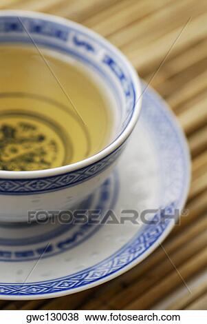 Stock Photo - Close-up of a cup of herbal tea on a saucer. Fotosearch