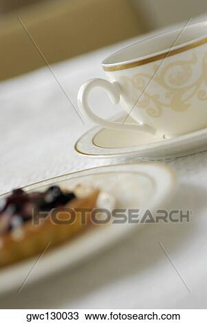Close-up of a cup of tea with a fruit tart View Large Photo Image Stock Image - Close-up of a cup of tea with a fruit tart. Fotosearch
