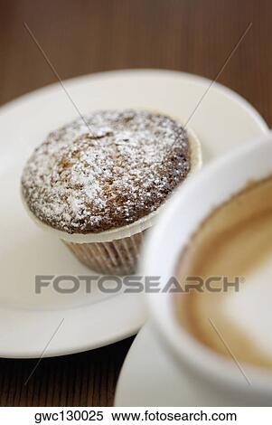 Close-up of a cupcake with a cup of tea View Large Photo Image Stock Photography - Close-up of a cupcake with a cup of tea. Fotosearch