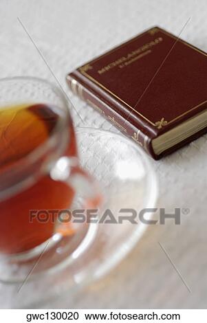 Close-up of black tea near a book View Large Photo Image Stock Image - Close-up of black tea near a book. Fotosearch