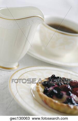 Close-up of tart with a cup of coffee View Large Photo Image Stock Image - Close-up of tart with a cup of coffee. Fotosearch