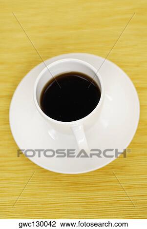 High angle view of a cup of black tea on a saucer View Large Photo Image Stock Image - High angle view of a cup of black tea on a saucer. Fotosearch