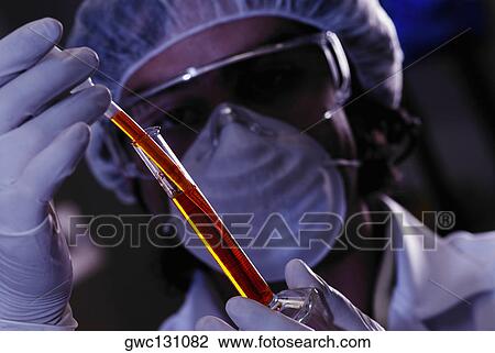 Close-up of a mid adult man using a measuring beaker and a pipette View Large Photo Image Stock Image - Close-up of a mid adult man using a measuring beaker and a pipette. Fotosearch