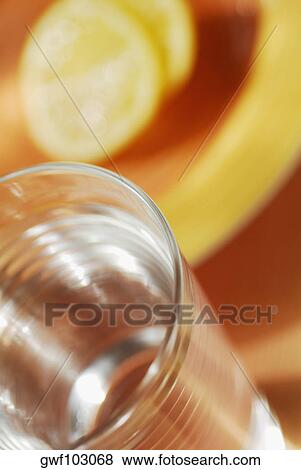 Close-up of a glass of water with slices of lemon View Large Photo Image Stock Photo - Close-up of a glass of water with slices of lemon. Fotosearch