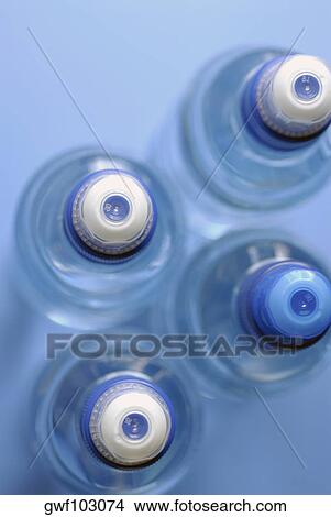 High angle view of four water bottles View Large Photo Image Picture - High angle view of four water bottles. Fotosearch