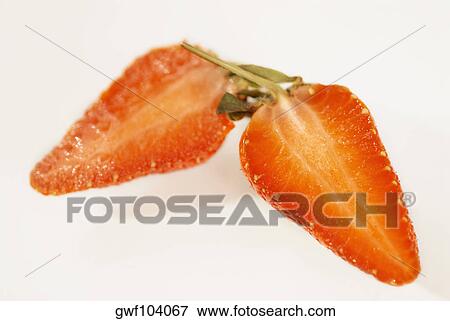 Close-up of a strawberry cut in half View Large Photo Image Stock Photo - Close-up of a strawberry cut in half. Fotosearch