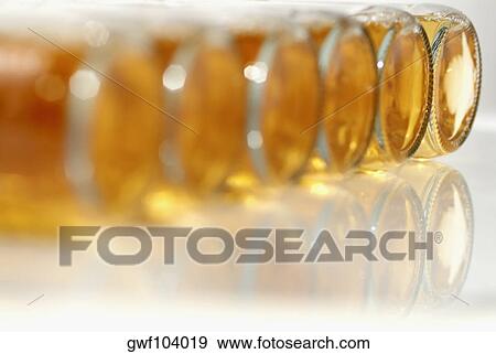 Close-up of bottles of apple juice View Large Photo Image Stock Photo - Close-up of bottles of apple juice. Fotosearch