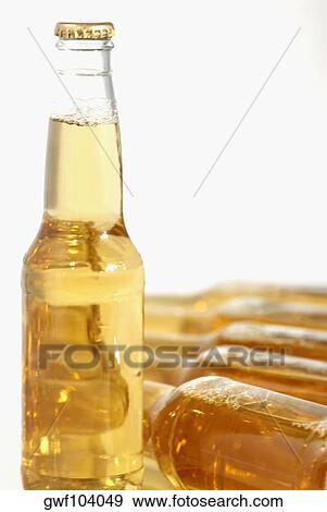 Stock Photo - Close-up of bottles of apple juice. Fotosearch