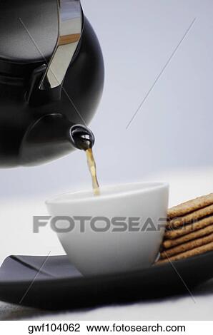 Close-up of tea pouring into a cup View Large Photo Image Stock Image - Close-up of tea pouring into a cup. Fotosearch