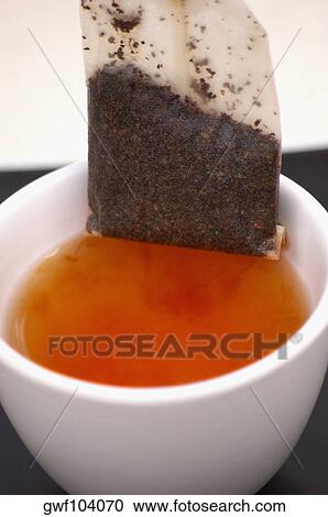 Stock Image - High angle view of a teabag in a cup. Fotosearch