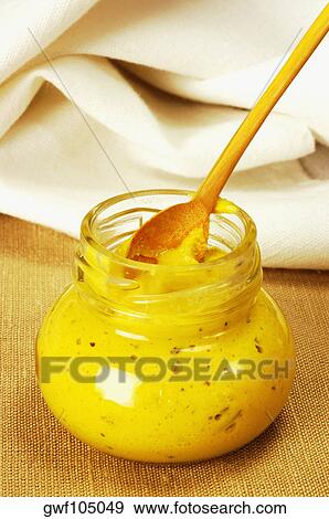 Close-up of a jar of mustard with a wooden spoon View Large Photo Image Stock Photo - Close-up of a jar of mustard with a wooden spoon. Fotosearch