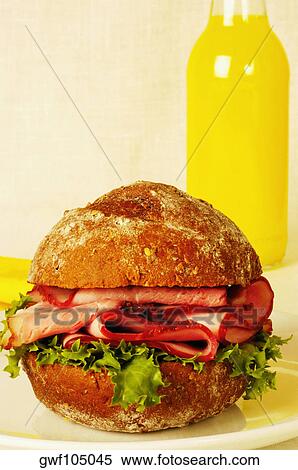 Close-up of a roast beef burger and a bottle of orange juice View Large Photo Image Stock Photography - Close-up of a roast beef burger and a bottle of orange juice. Fotosearch