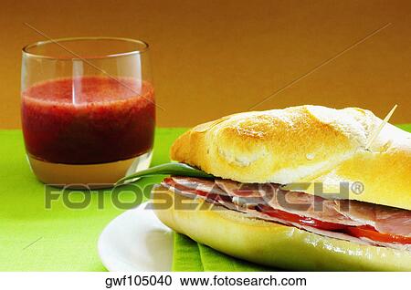 Close-up of a sandwich with a glass of juice View Large Photo Image Stock Image - Close-up of a sandwich with a glass of juice. Fotosearch