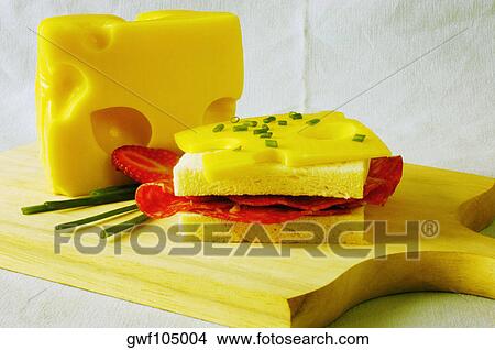 Close-up of a sandwich with slices of cheese on a cutting board View Large Photo Image Picture - Close-up of a sandwich with slices of cheese on a cutting board. Fotosearch
