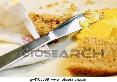 Close-up of a table knife with brown bread and cheese View Large Photo Image Stock Photo - Close-up of a table knife with brown bread and cheese. Fotosearch