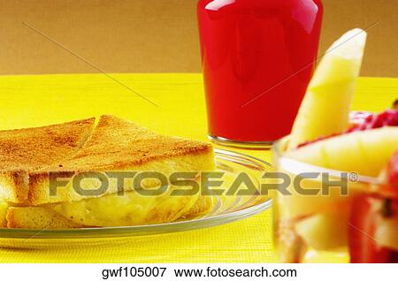 Close-up of bread and fruit salad with a glass of juice View Large Photo Image Stock Photo - Close-up of bread and fruit salad with a glass of juice. Fotosearch