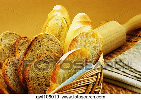 Close-up of bread in a basket and a roller pin on a place mat View Large Photo Image Stock Photo - Close-up of bread in a basket and a roller pin on a place mat. Fotosearch