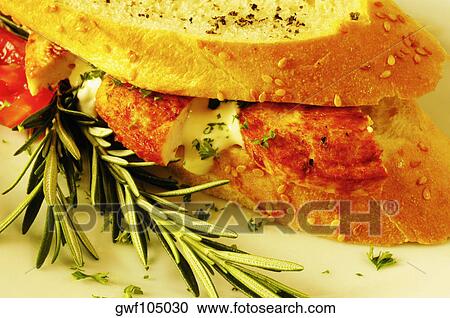 Stock Image - Close-up of bread with rosemary leaves. Fotosearch