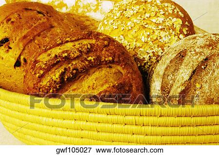 Close-up of brown bread and buns in a basket View Large Photo Image Stock Photo - Close-up of brown bread and buns in a basket. Fotosearch