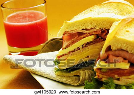 Close-up of roast beef and cheese sandwiches near a glass of fruit juice View Large Photo Image Stock Image - Close-up of roast beef and cheese sandwiches near a glass of fruit juice. Fotosearch