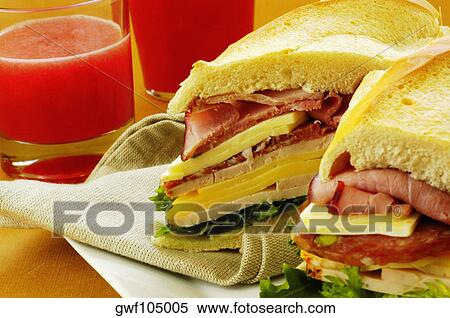 Close-up of roast beef and cheese sandwich near a glass of fruit juice View Large Photo Image Stock Photography - Close-up of roast beef and cheese sandwich near a glass of fruit juice. Fotosearch