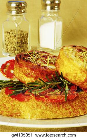 Close-up of roast meat on a plate with a salt shaker and a pepper shaker View Large Photo Image Stock Image - Close-up of roast meat on a plate with a salt shaker and a pepper shaker. Fotosearch