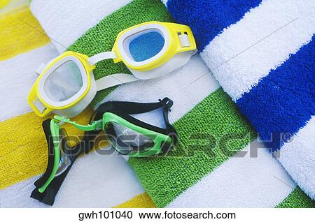 Close-up of two swimming goggles on rolled up towels View Large Photo Image Stock Image - Close-up of two swimming goggles on rolled up towels. Fotosearch