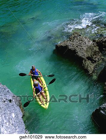 Stock Photo - High angle view of two people rafting in the sea, Bermuda. Fotosearch