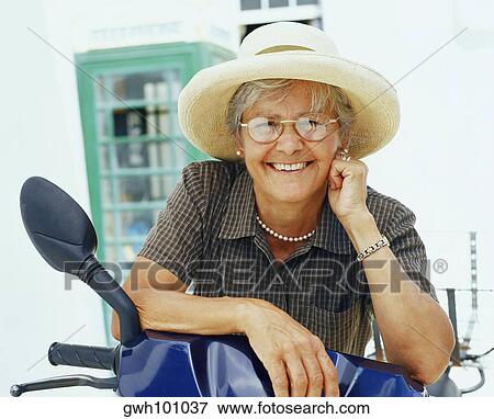 Portrait of a senior woman with her scooter and smiling, Bermuda View Large Photo Image Stock Photo - Portrait of a senior woman with her scooter and smiling, Bermuda. Fotosearch