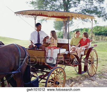 Young couple and their daughter sitting in a carriage and looking at each other, Bermuda View Large Photo Image Stock Image - Young couple and their daughter sitting in a carriage and looking at each other, Bermuda. Fotosearch