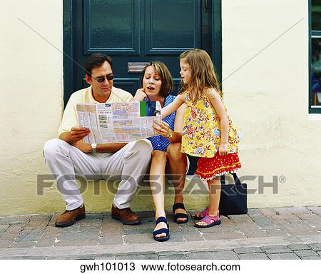 Young couple reading a newspaper with their daughter standing near them, Bermuda View Large Photo Image Stock Image - Young couple reading a newspaper with their daughter standing near them, Bermuda. Fotosearch