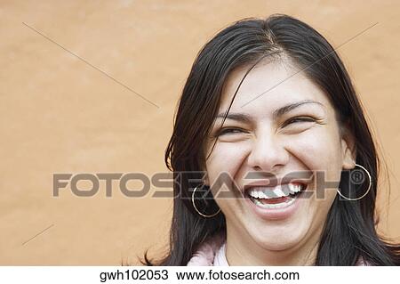 Close-up of a young woman laughing View Large Photo Image Stock Image - Close-up of a young woman laughing. Fotosearch