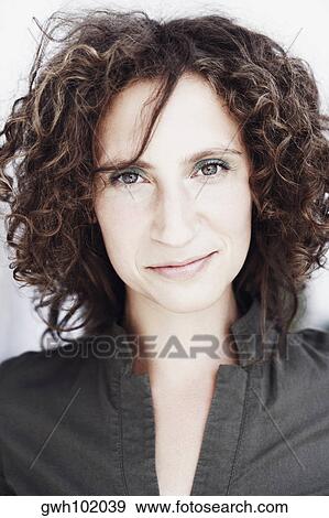 Stock Photo - Portrait of a mid adult woman smirking. Fotosearch