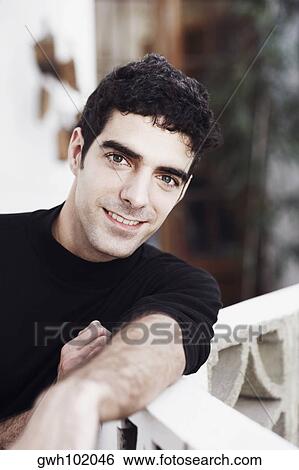 Portrait of a young man smiling View Large Photo Image Stock Photograph - Portrait of a young man smiling. Fotosearch