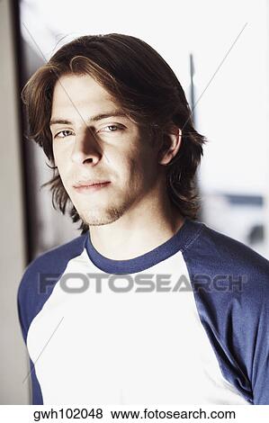 Stock Photo - Portrait of a young man smirking. Fotosearch
