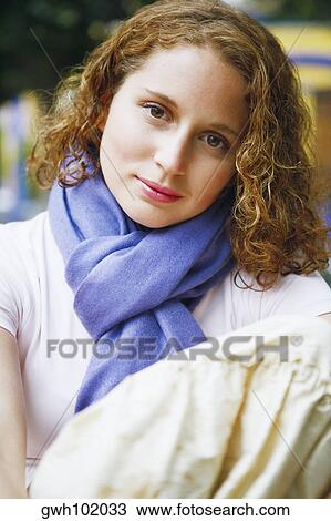 Portrait of a young woman hugging her knees View Large Photo Image Stock Image - Portrait of a young woman hugging her knees. Fotosearch