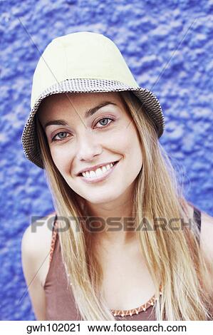 Portrait of a young woman wearing a hat View Large Photo Image Stock Image - Portrait of a young woman wearing a hat. Fotosearch