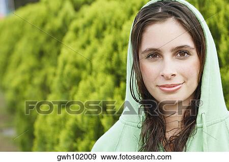 Portrait of a young woman wearing a hooded shirt View Large Photo Image Stock Photo - Portrait of a young woman wearing a hooded shirt. Fotosearch